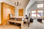 Murphy bed sits behind the table which opens the space up a bit